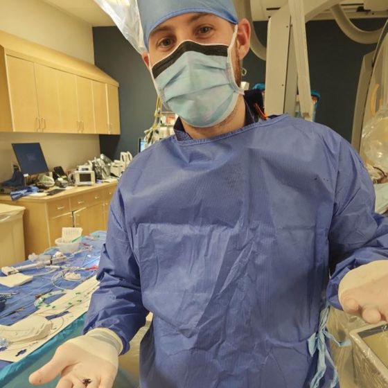 Brandon in hospital scrubs at his old job